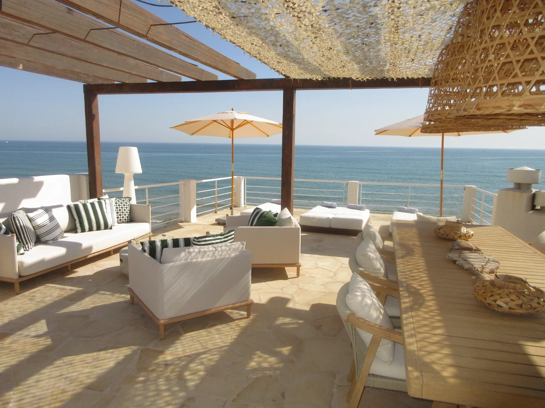 Rooftop terrace with lounge area, parasols and sea view
